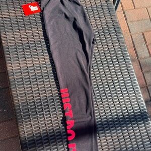 New with tags Nike Black Leggings with red accents. Size Medium
